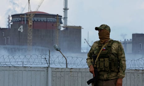 A Russian soldier stands guard near the Zaporizhzhia nuclear power plant in Ukraine.