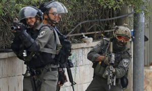 Israeli troops take position as they clash with Palestinian youth near Ramallah in the occupied West Bank.