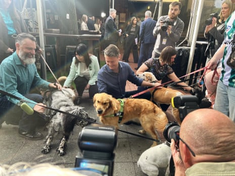 Ben Carroll meeting dogs at a press conference at the London Tavern in Richmond