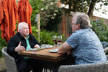 Don and David chatting at an outside restaurant table