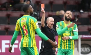 Semi Ajayi is shown a red card by referee Mike Dean.