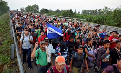 Migrants from Central America and Cuba walk on a highway during their journey towards the United States, in Tuzantan, in Chiapas state, on Monday.