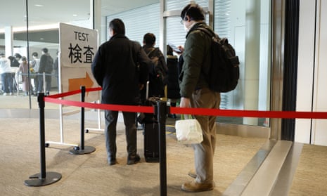 Passengers from Shanghai, China, queue for compulsory Covid tests at Narita airport in Japan.