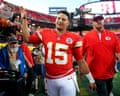 Patrick Mahomes waves and smiles while walking off the field past cheering fans