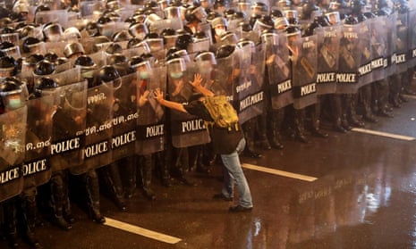 A protester with riot police during a protest calling for reform of the monarchy in Bangkok, Thailand, 16 October 2020