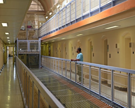 A prisoner stands outside his cell on C wing of Wandsworth prison.
