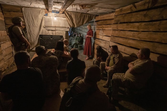 Medic volunteer Nataliia Voronkova, top right, gives a medical tactical training session to soldiers in a bomb shelter as air raid sirens go off, in Dobropillya, eastern Ukraine.