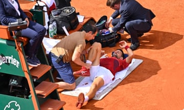 Novak Djokovic is treated by the doctor during his fourth-round match against Francisco Cerúndolo.