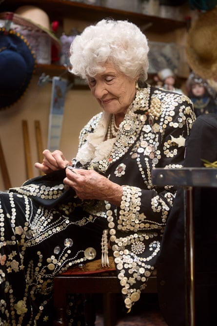 Phyllis Broadbent sewing pearls on to an item of clothing