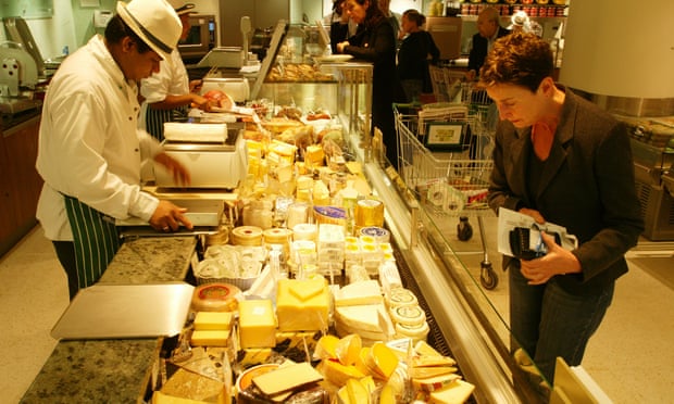 Shoppers at cheese counter.
