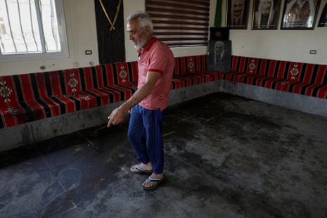 Hatem Radwan points to bloodstains inside the Al-Radwan guest house, after a deadly shooting, in the predominantly Druze city of Sweida, Syria.