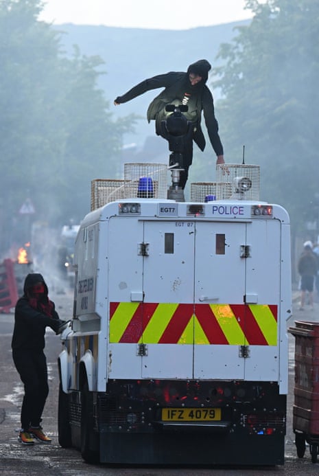 Protestors attack a Police vehicle on Sandy Row in Belfast, Northern Ireland.