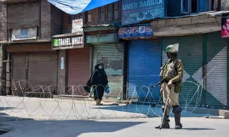 Barbed wire blocks off a road during the Covid-19 lockdown in Srinagar, India. The country is preparing to reopen the neighbourhood shops that serve most of its 1.3 billion people.