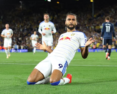 Dominic Calvert-Lewin slides on his knees after scoring Leeds' third goal