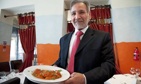 Man holding plate of curry