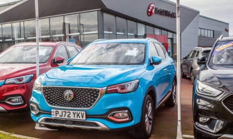 New and used cars displayed for sale on car dealer’s forecourt