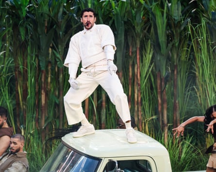 Bad Bunny stands on a white truck during his half-time Super Bowl show.
