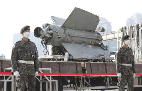South Korean soldiers stand in front of the debris of a North Korean missile recovered from the sea this month.
