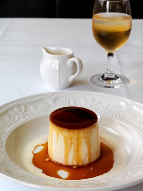 Crème caramel in a white dish with pudding wine