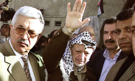 Then Palestinian president, Yasser Arafat, centre, waves good-bye to Egyptian intelligence chief Omar Suleiman with premier-designate Mahmoud Abbas, left, in Ramallah in 2003.