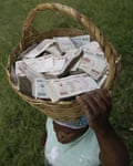 A Zimbabwean lady with a basketful of cash