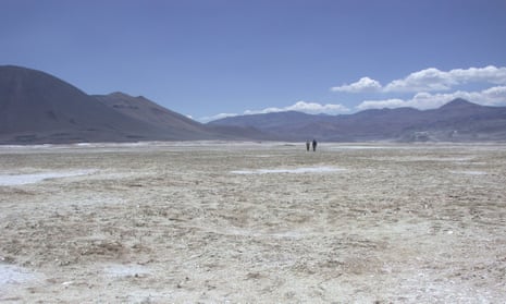Randomly oriented, finger-length gypsum crystals give a shiny quality to the ground among the Salar de Gorbea dunes in the Andes.