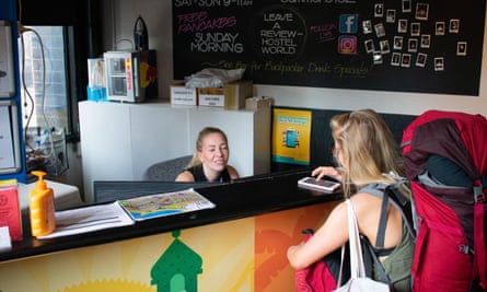 Backpacker checking into reception at hostel in Melbourne Australia