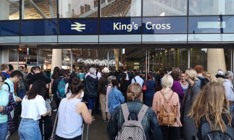 People wait outside King’s Cross station, London, as a large power cut causes disruption across England and Wales on 9 August.