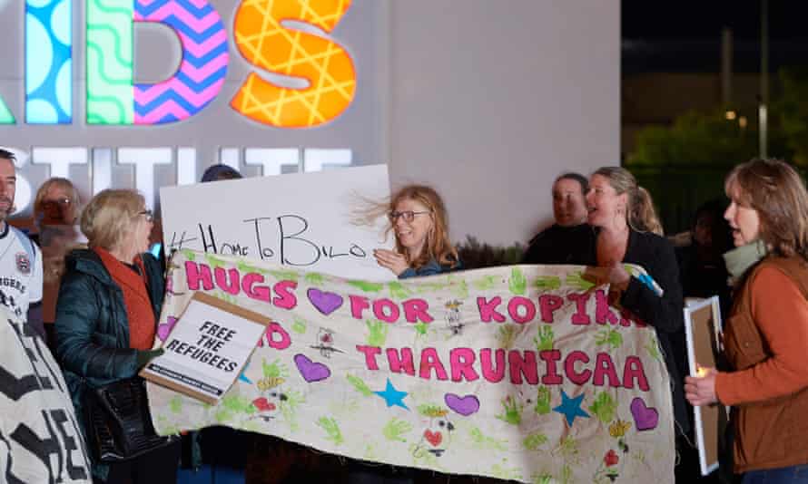 people hold a banners outside Perth hospital