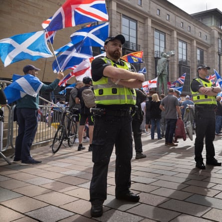 Police officers stand guard at a protest