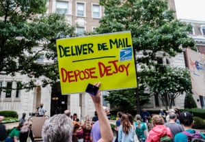 Demonstrators protest against Louis DeJoy outside his home in Washington DC, on 15 August.