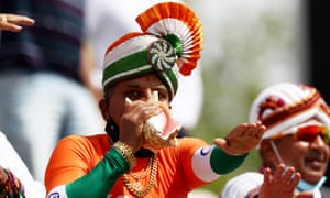 India cricket fan blows into a shell.