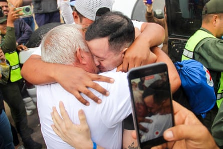 A father and son embrace each other
