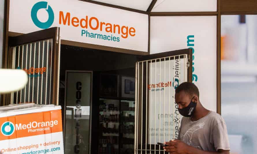 A man walks infront of a pharmacy in Harare.