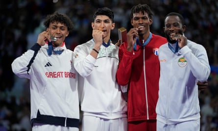 Caden Cunningham (left) savours his silver along with the other medallists (left to right), champion Arian Salimi, and bronze medal winners Cuba’s Rafael Alba and Ivory Coast’s Cheick Sallah Cisse.