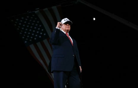 Trump raises a clenched fist at a campaign rally at Pitt-Greenville Airport in Greenville, North Carolina, on Tuesday night.