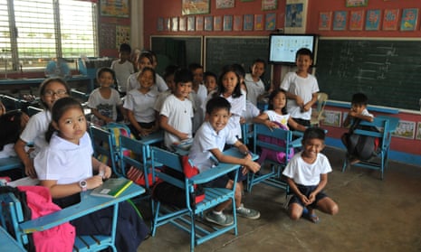 Children at their desks in a primary school class in the Philippines.