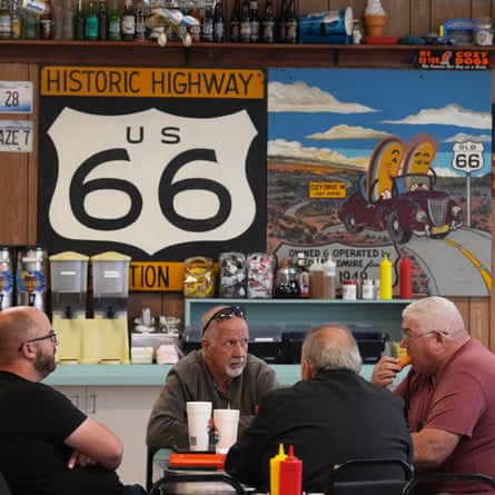 Four men sitting at a table in a diner