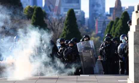 Police officers advance towards protesters at Melbourne's Shrine of Remembrance