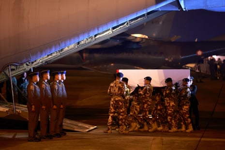 Soldiers carry the coffins of the fallen Indonesian UN peacekeepers who were killed while serving in Lebanon onto a military aircraft in Jakarta.
