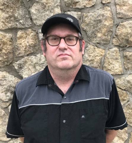a man in front of a stone wall