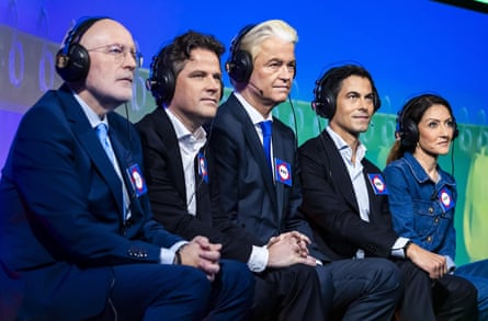 They sit in a row wearing headphones