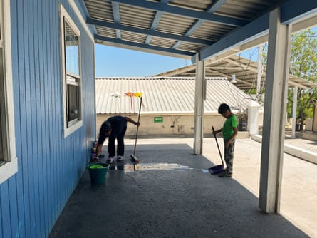 a mother and a son clean a shelter
