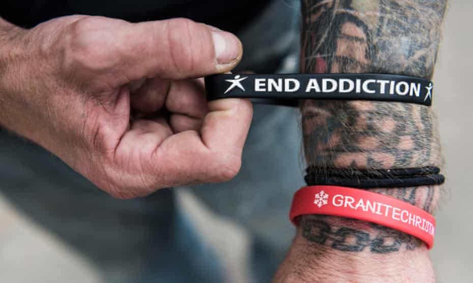 A man shows off an end addiction bracelets
