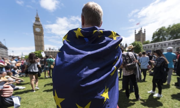 A protester wraps an EU flag around himself during an anti-Brexit march near the Houses of Parliament in London.