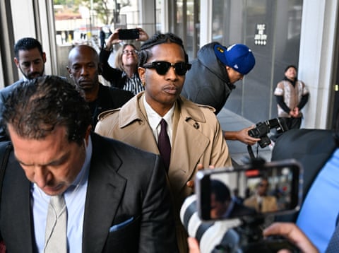 A young man in sunglasses surrounded by media.