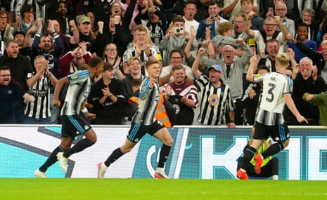 Harvey Barnes and a teammate celebrate scoring a goal past cheering Newcastle fans