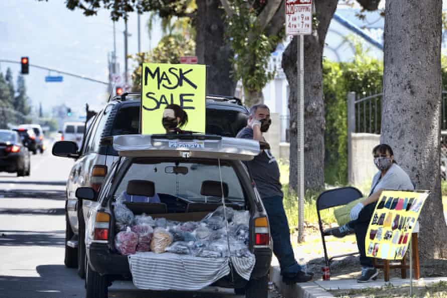 Vendors selling masks at the roadside in Los Angeles this week.