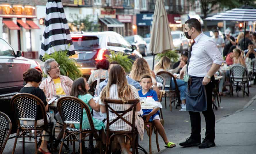 People dine in parking spaces on the street outside CEBU restaurant in Brooklyn, New York.