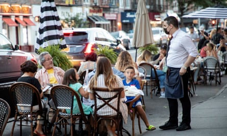 People dine in parking spaces on the street outside CEBU restaurant in Brooklyn, New York.